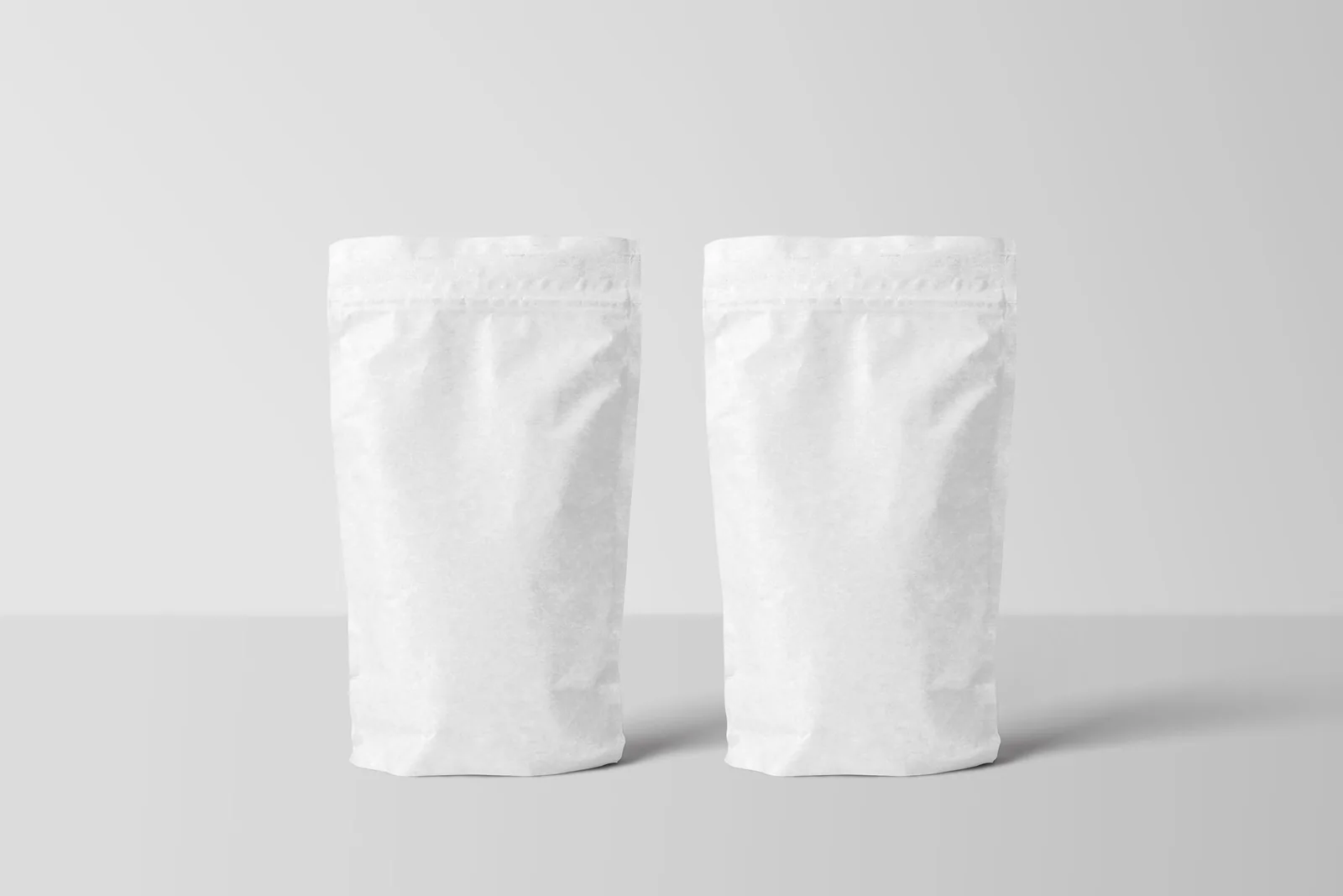 Two blank white stand-up pouches
